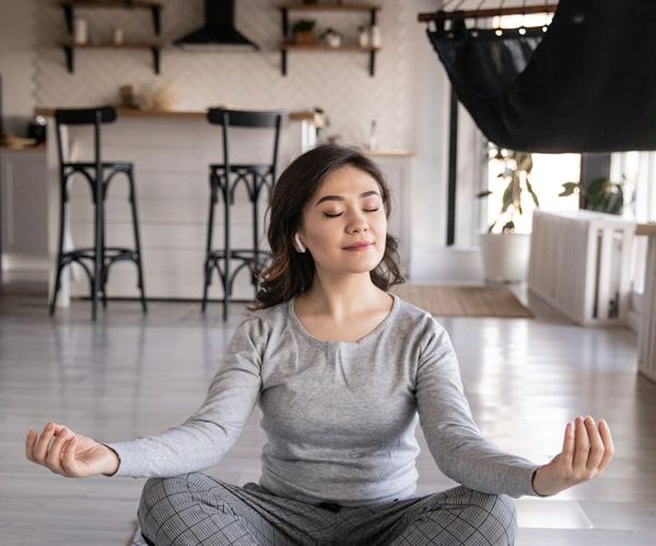 A calm and organized corner of a room with a yoga mat, ready for practice.