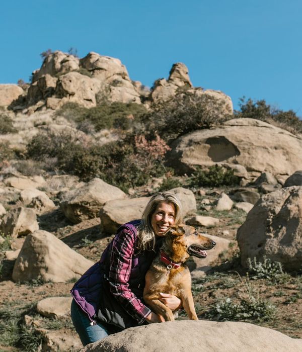 Woman feeling energetic and balanced in a natural, sunny environment.